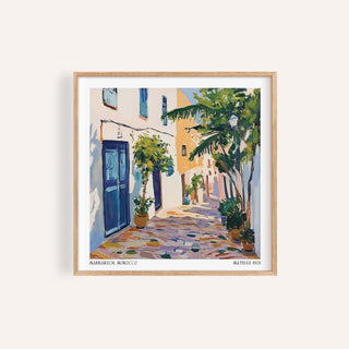 Morocco wall art of a Mediterranean street scene with blue doors and greenery in a wooden frame