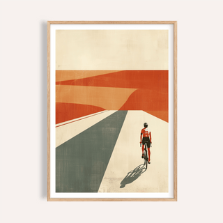 Framed cycling landscape print of a cyclist in red riding into an abstract desert with orange and grey shapes