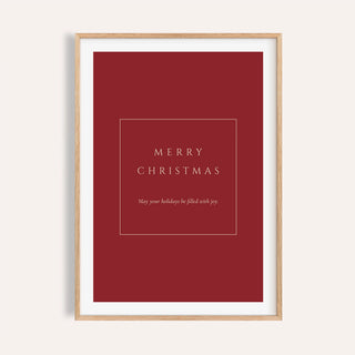 Red Merry Christmas typography print shown on a plain warm wall