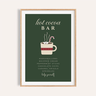 Green hot cocoa bar sign print shown on a plain warm wall