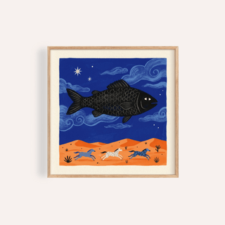 Framed print close-up of whimsical fish art print with a black fish flying over orange hills in blue sky
