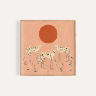 Framed close-up of cheetah art print showing three minimalist cheetahs with a red sun