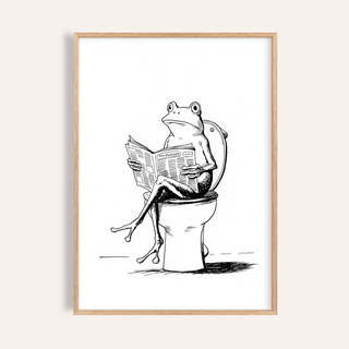Framed Cartoon Frog wall art of a frog reading on a toilet in black and white