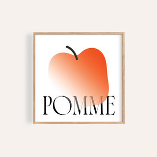 Framed print close-up of a minimalist apple art print with orange gradient and typographic text POMME