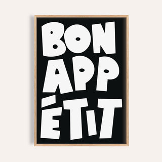 Kitchen wall art with bold white bon appétit text on black background in minimalist style