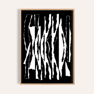 Framed abstract black and white torn stripes artwork with a light wood frame