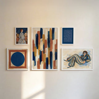 Modern Gallery Wall Set of abstract and figurative prints in blue beige and terracotta on a pale wall