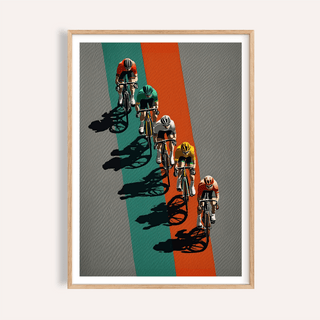 Framed close-up of biking wall art showing cyclists in coloured jerseys on grey and orange background