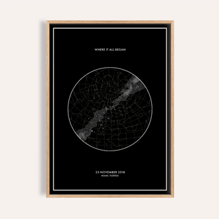 Framed Custom Star Map with minimalist black and white design on a pale wall