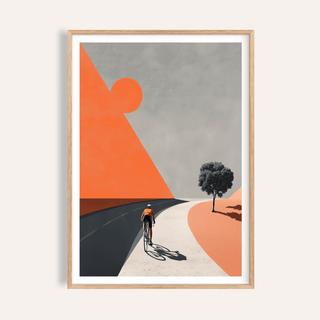 Framed print close-up of a cyclist riding on a two-tone road with a single tree in muted colours