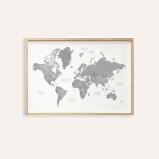 Framed print close-up of world map art in minimalist grey and white on a pale background