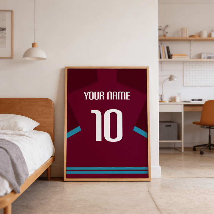 Football Shirt Poster in Claret with Light Blue Sleeve Trim leaning on the floor next to a bed in a bedroom