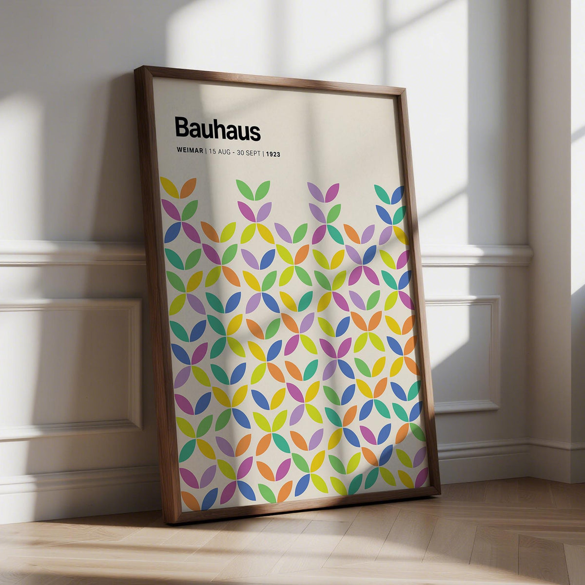 Framed Colorful Bauhaus Poster leaning on a floor with natural light and shadows