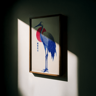 Blue Crane Art framed print close-up with blue bird and red circle lit by sunlight on a wall