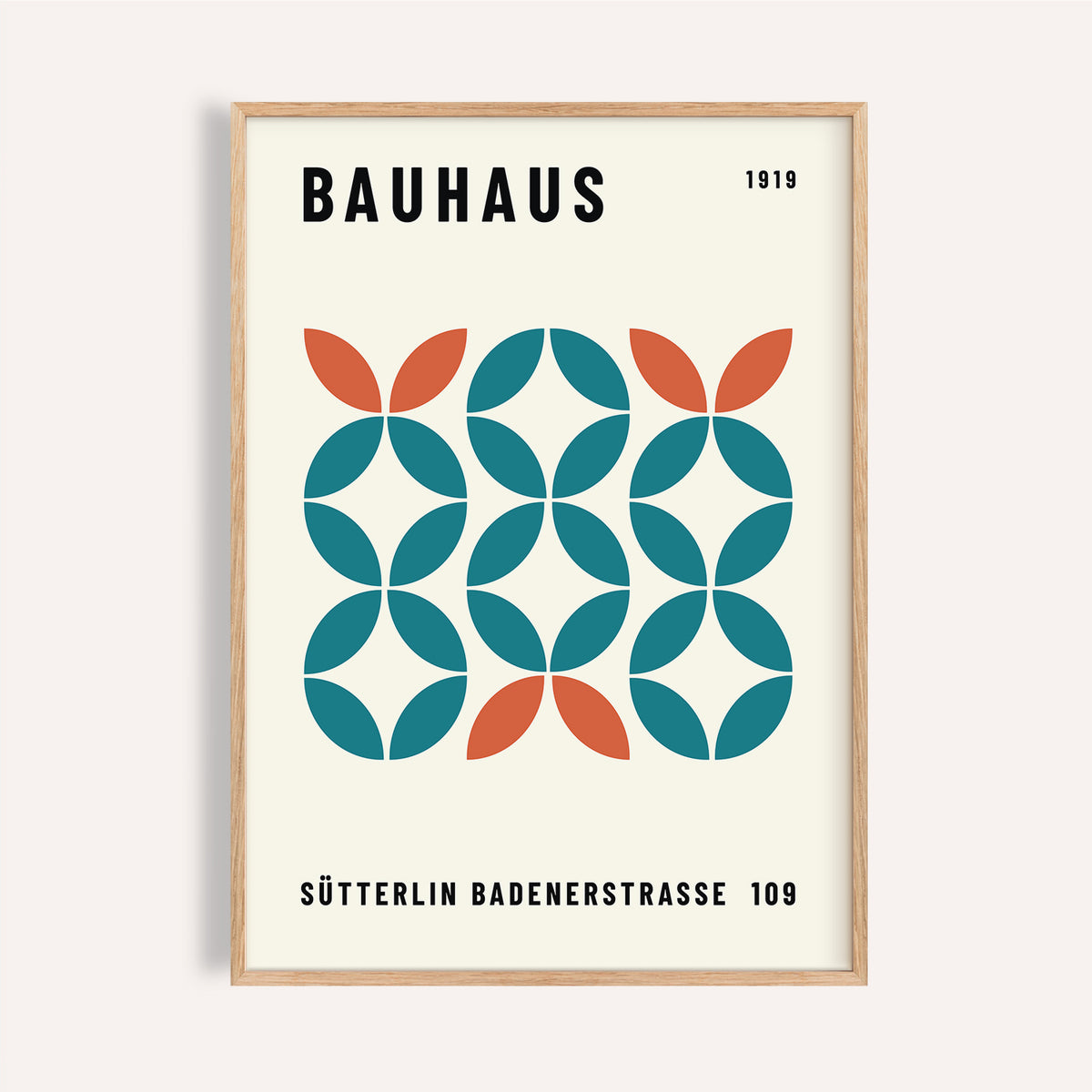 Framed print showing a geometric bauhaus pattern with teal and orange shapes on cream background