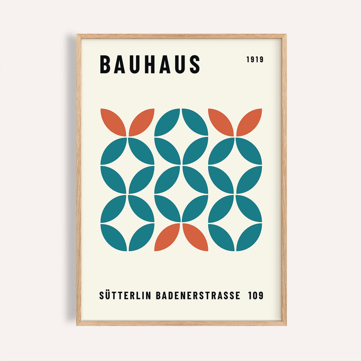 Framed print showing a geometric bauhaus pattern with teal and orange shapes on cream background
