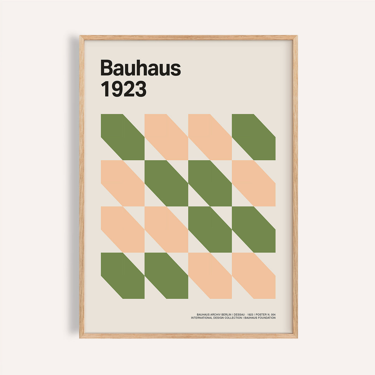Framed close-up of Mid Century art prints with green and peach geometric shapes in Bauhaus style