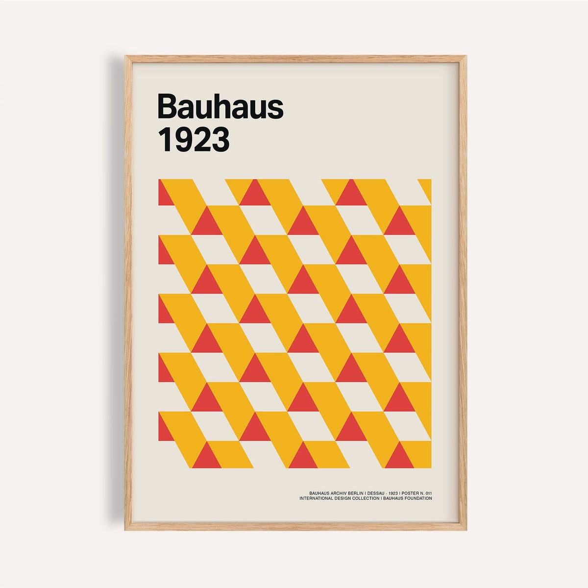 Framed print close-up of geometric triangles in yellow and red with text Bauhaus 1923