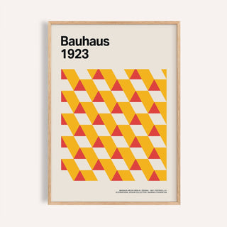 Framed print close-up of geometric triangles in yellow and red with text Bauhaus 1923