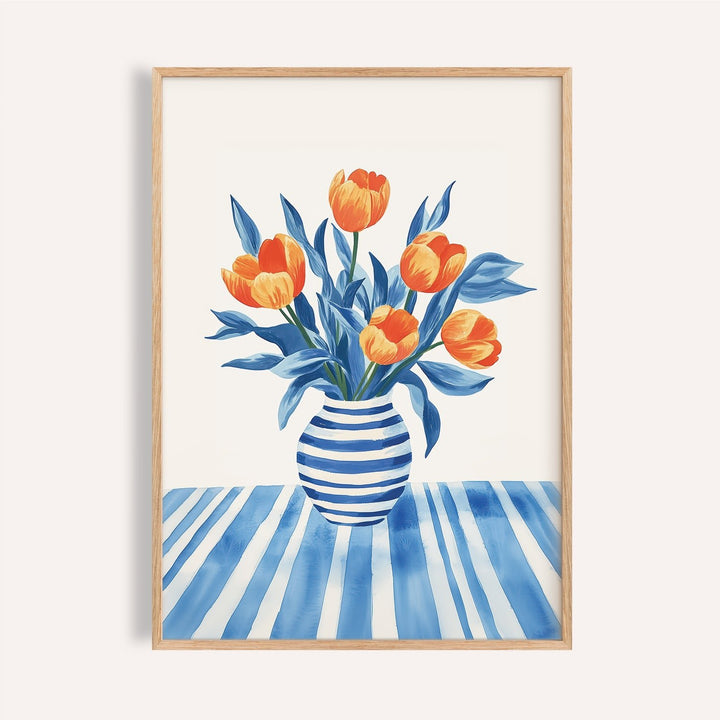 Framed print of orange striped tulips in a blue and white striped vase and tablecloth