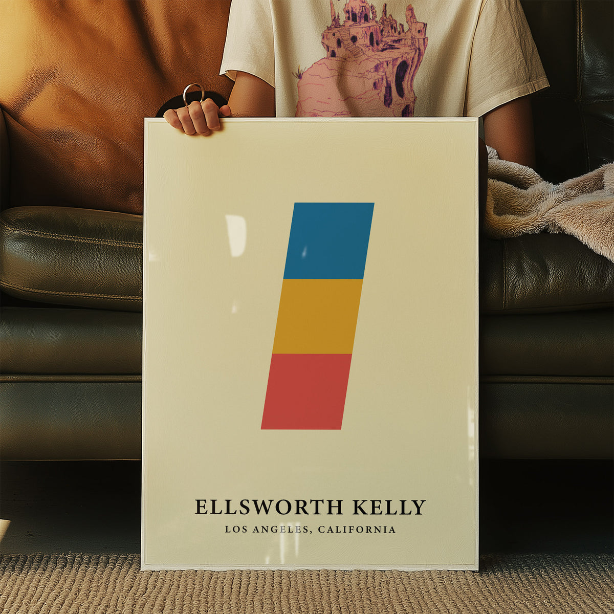 Creative wall art of stacked coloured blocks in blue yellow and red held in hands on a sofa