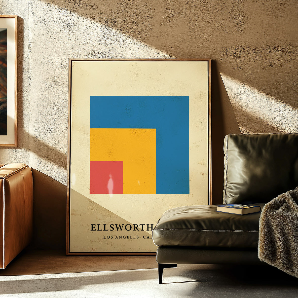 Modern Minimal Wall Art leaning print of colourful nested squares near a leather armchair with a book
