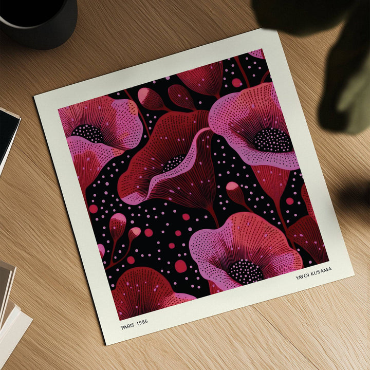 Abstract pink art showing pink and red poppy flowers with black details lying on a wooden surface