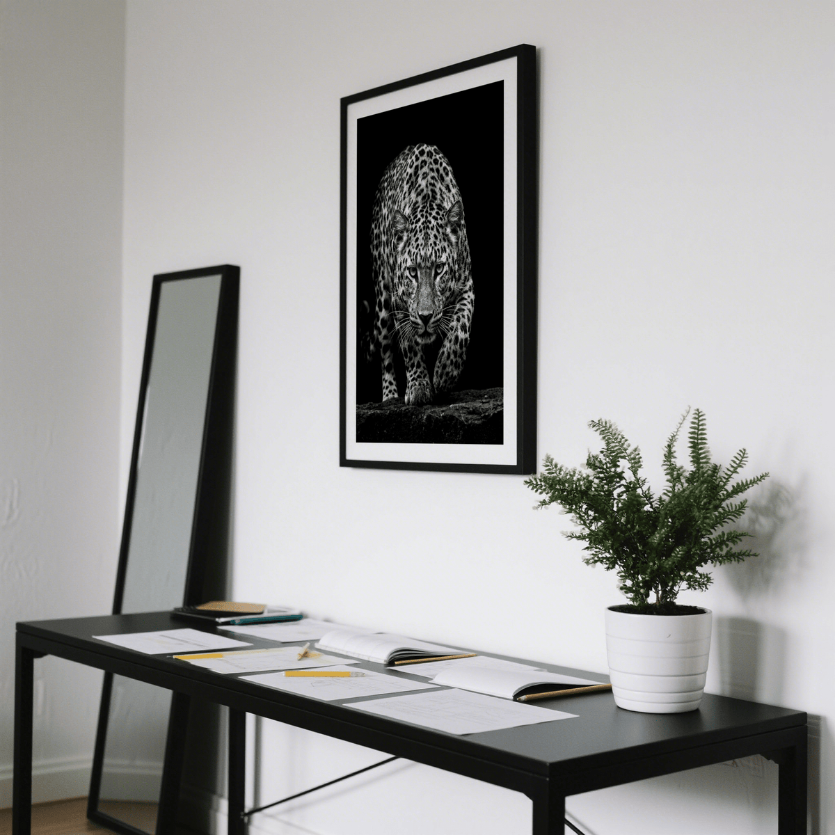 Black Leopard wall art photographic close-up of a stalking leopard in black and white above a desk with plant