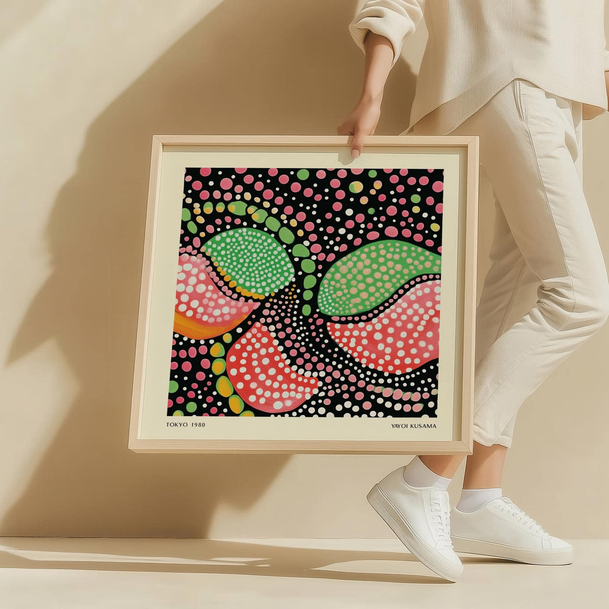 Framed Green Pink Art of colourful abstract fruit shapes in green pink and black held by a person
