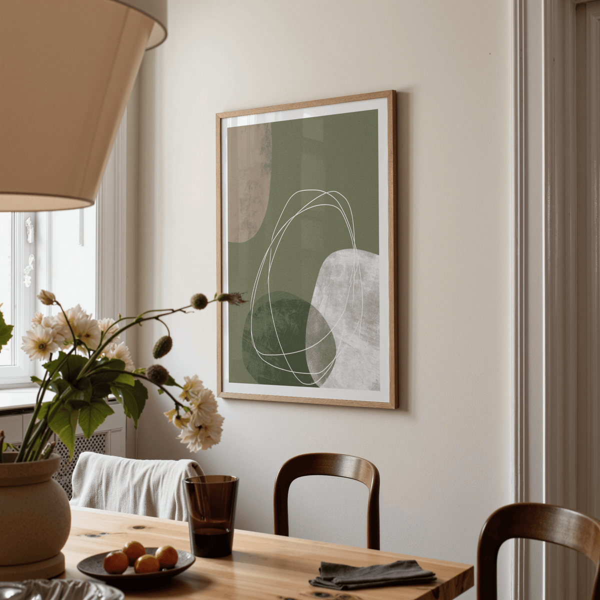 Modern Organic Print wall art with green and white abstract shapes above a wooden dining table
