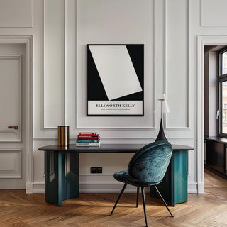 Black and White Office Print above a desk with books and a lamp in an office