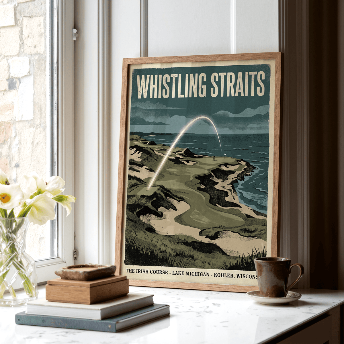 Print of Lakeside Links Golf Poster leaning on a windowsill with books and a cup nearby