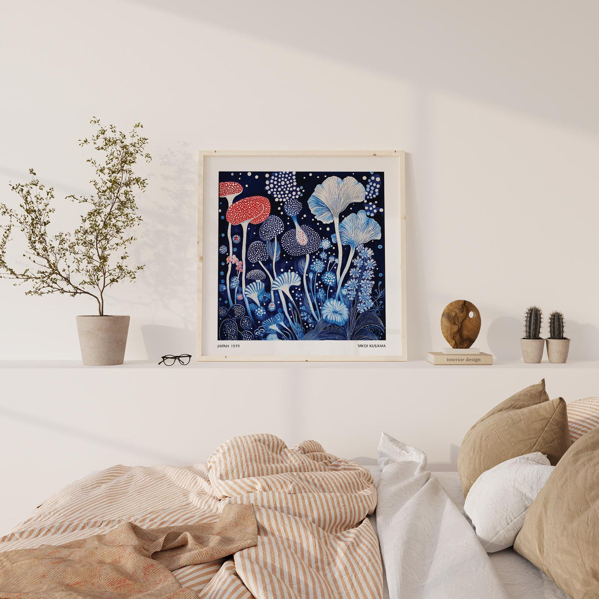 Red and Blue wall art showing mushrooms with spotted caps placed above bed with cushions