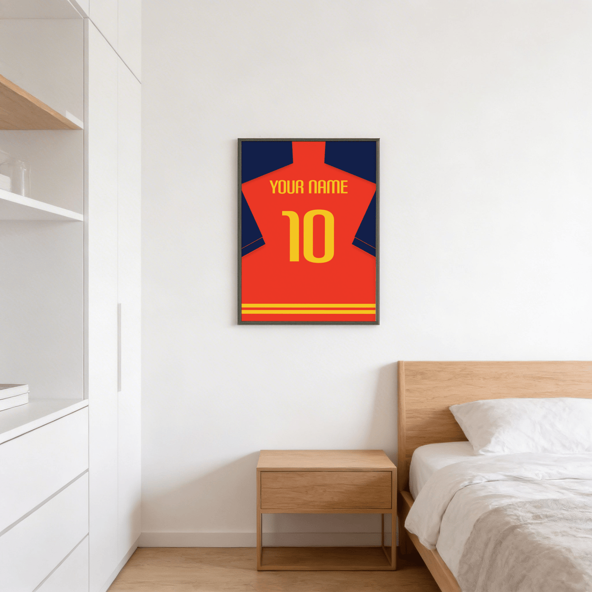Football Shirt Poster in Red with Navy Sleeves and Yellow Number hanging above a wooden bedside table in a bedroom