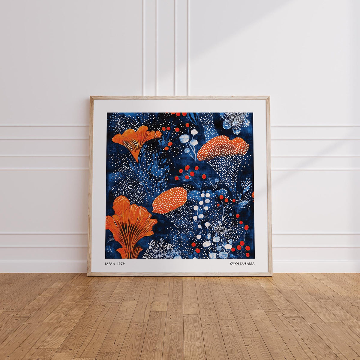 Blue Orange wall art leaning on a wooden floor with an orange floral pattern and white dots