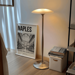 Galleria Umberto art print leaning on the floor next to a tall lamp in a room