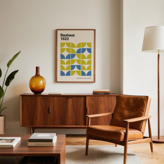 Print on a wall in a cosy living room with Bauhaus geometric art and blue and lime green blocks near a wooden sideboard
