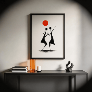 Framed Warli Folk Art print of tribal dancers in black and red above a console table with a small sculpture