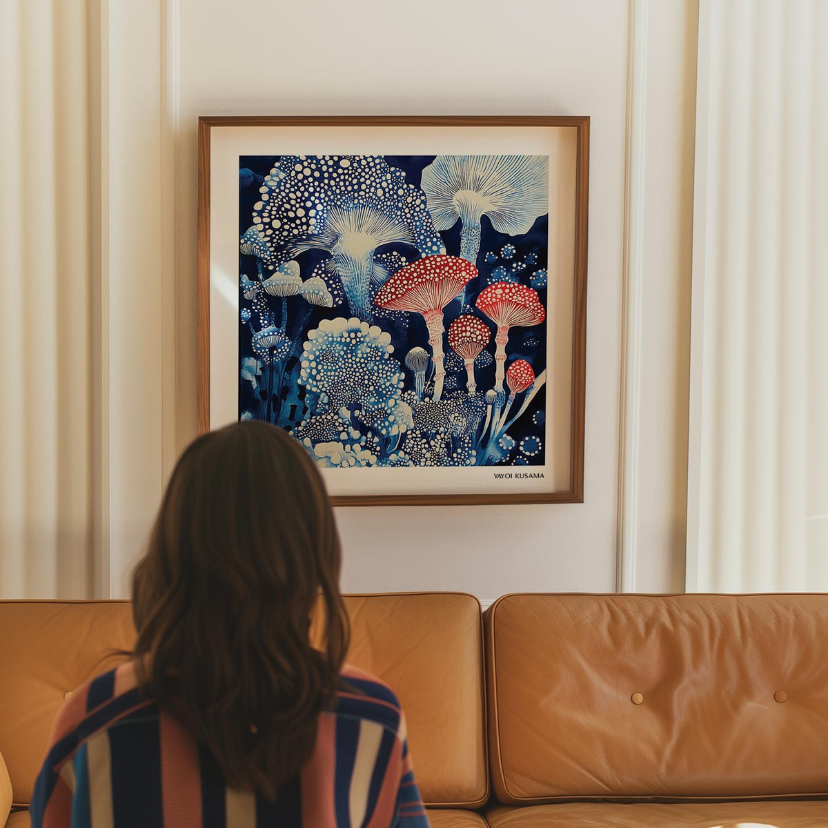 Japanese Poster hung above a sofa with blue and red toadstools in an illustration style