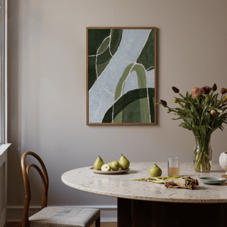 Green and Blue Art print with abstract blue and green shapes above a dining table with fruit and flowers