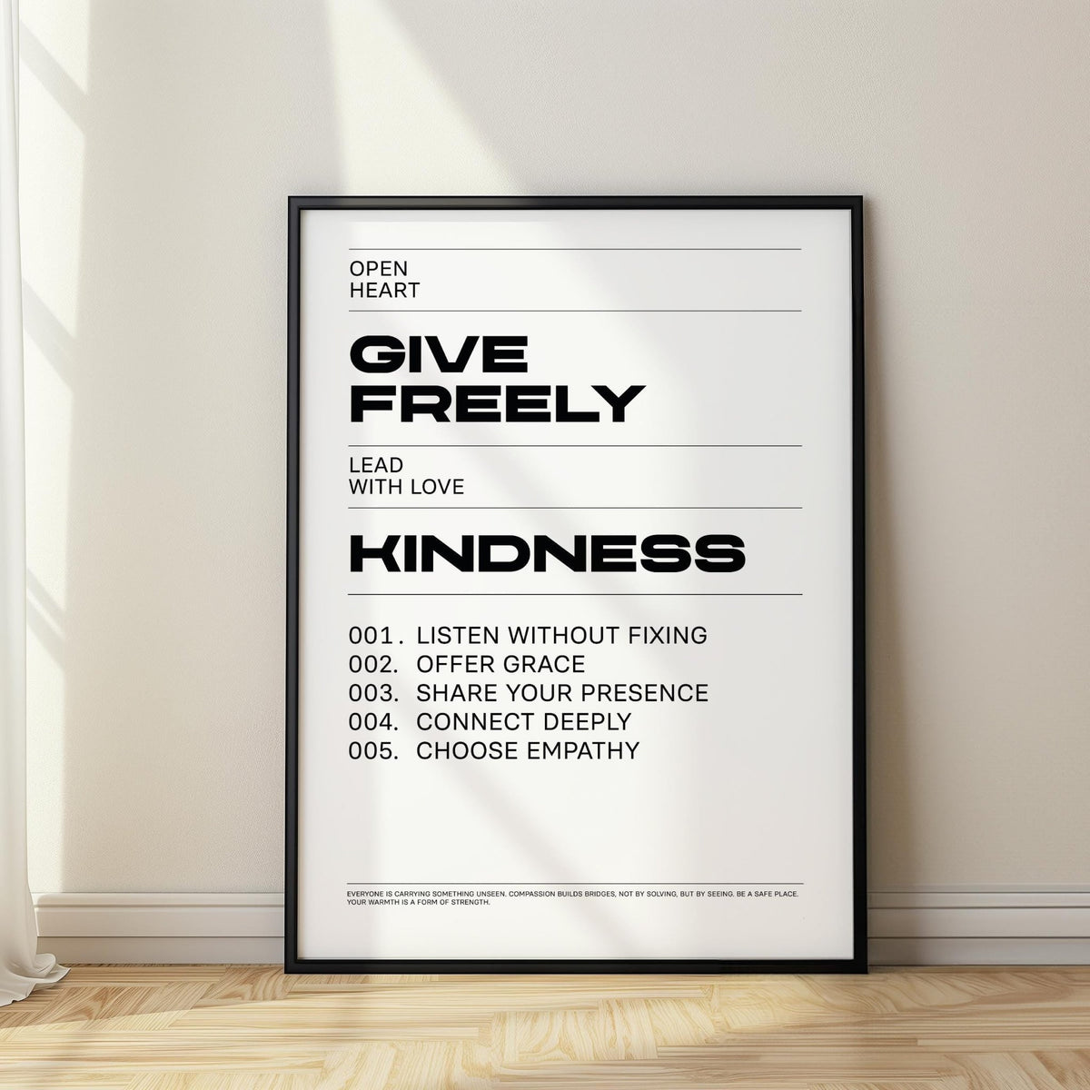 Art with Quotes black and white kindness typography print leaning on the floor beside a window