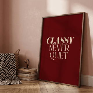 Print leaning on the floor with Classy Wall Art text quote in beige on dark red with a zebra print throw