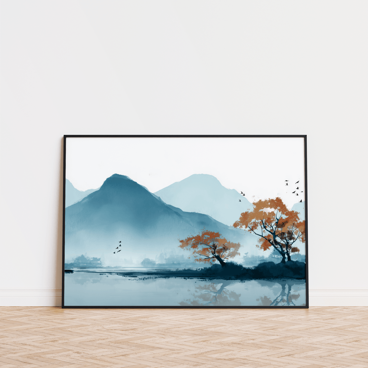 Nature wall art print of a misty mountain lake with blue and orange tones leaning on a wooden floor