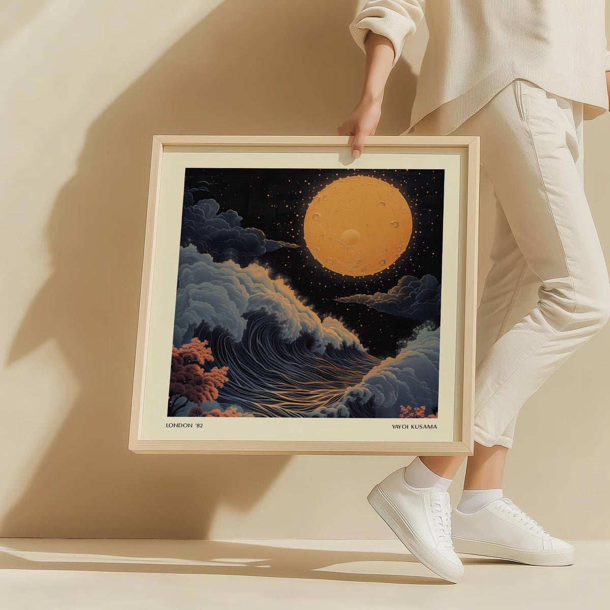 Person holding Japanese Art Pictures framed print of a surreal full moon with waves and clouds in dark tones