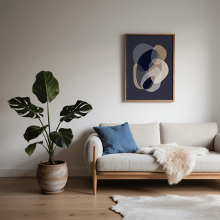 Prints Abstract Art with beige and grey organic shapes above a beige sofa and blue cushion