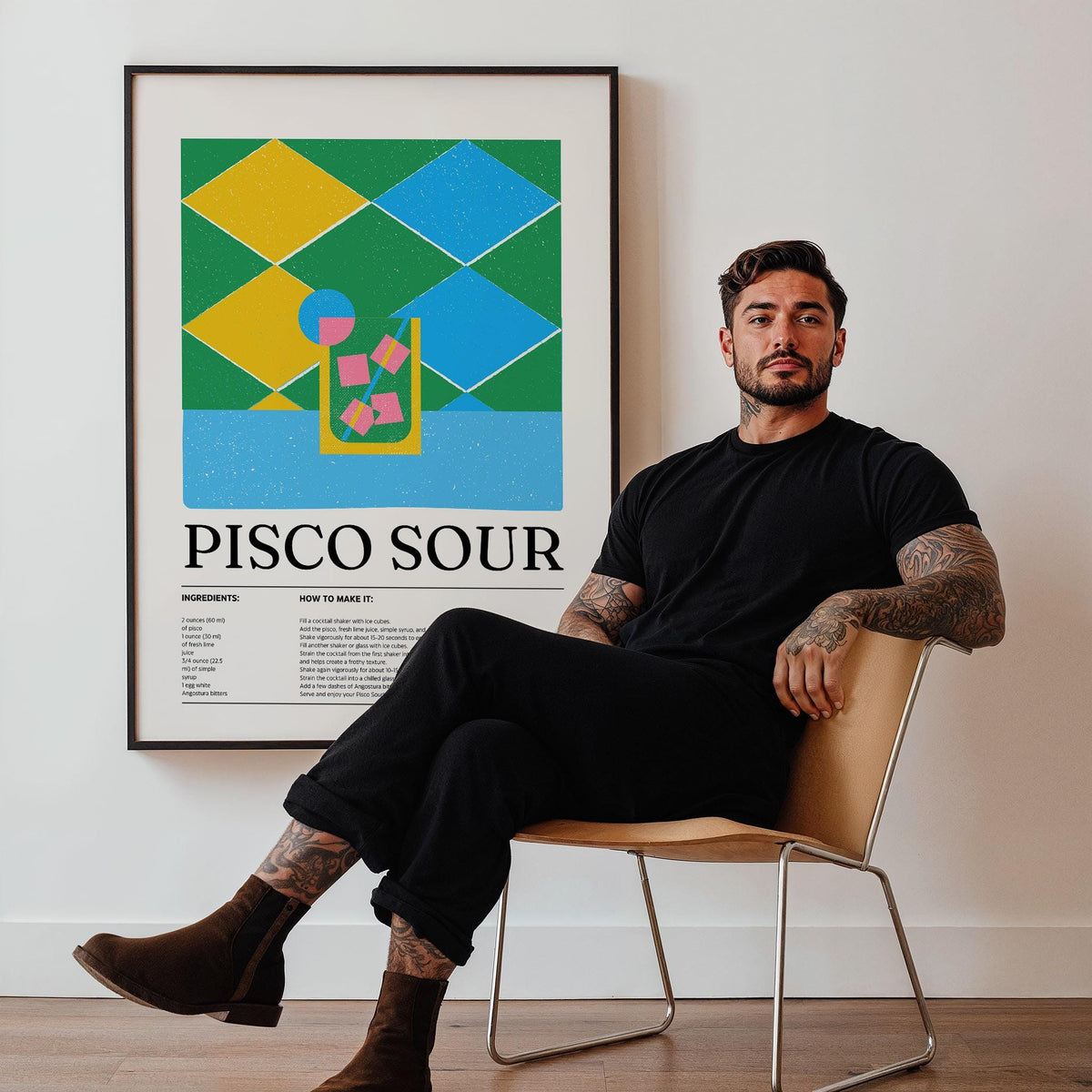 Print leaning on a wall with the pisco sour illustration in blue, green and yellow and a man seated nearby