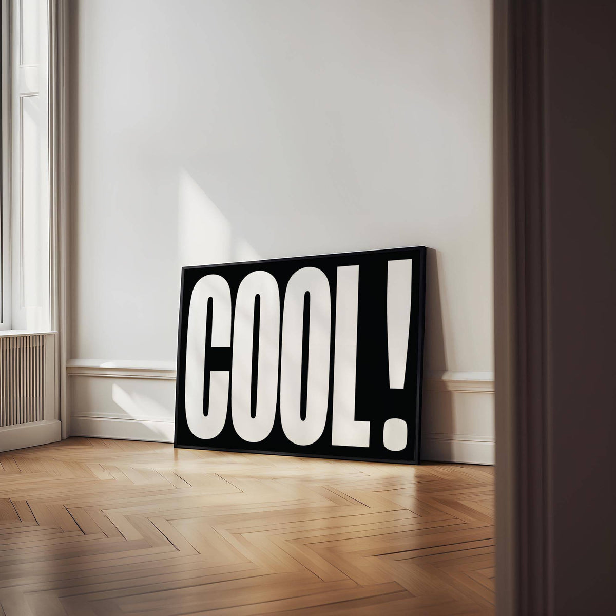 Cool Typography Art leaning print with bold white letters on a black background on wooden floor