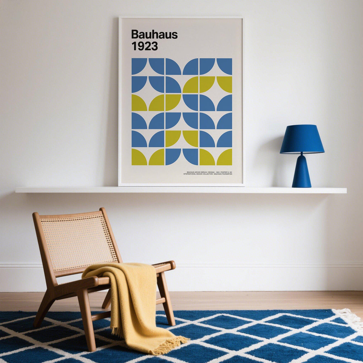 Modern Office Wall Decor with blue and green geometric shapes on a white shelf with a blue lamp nearby