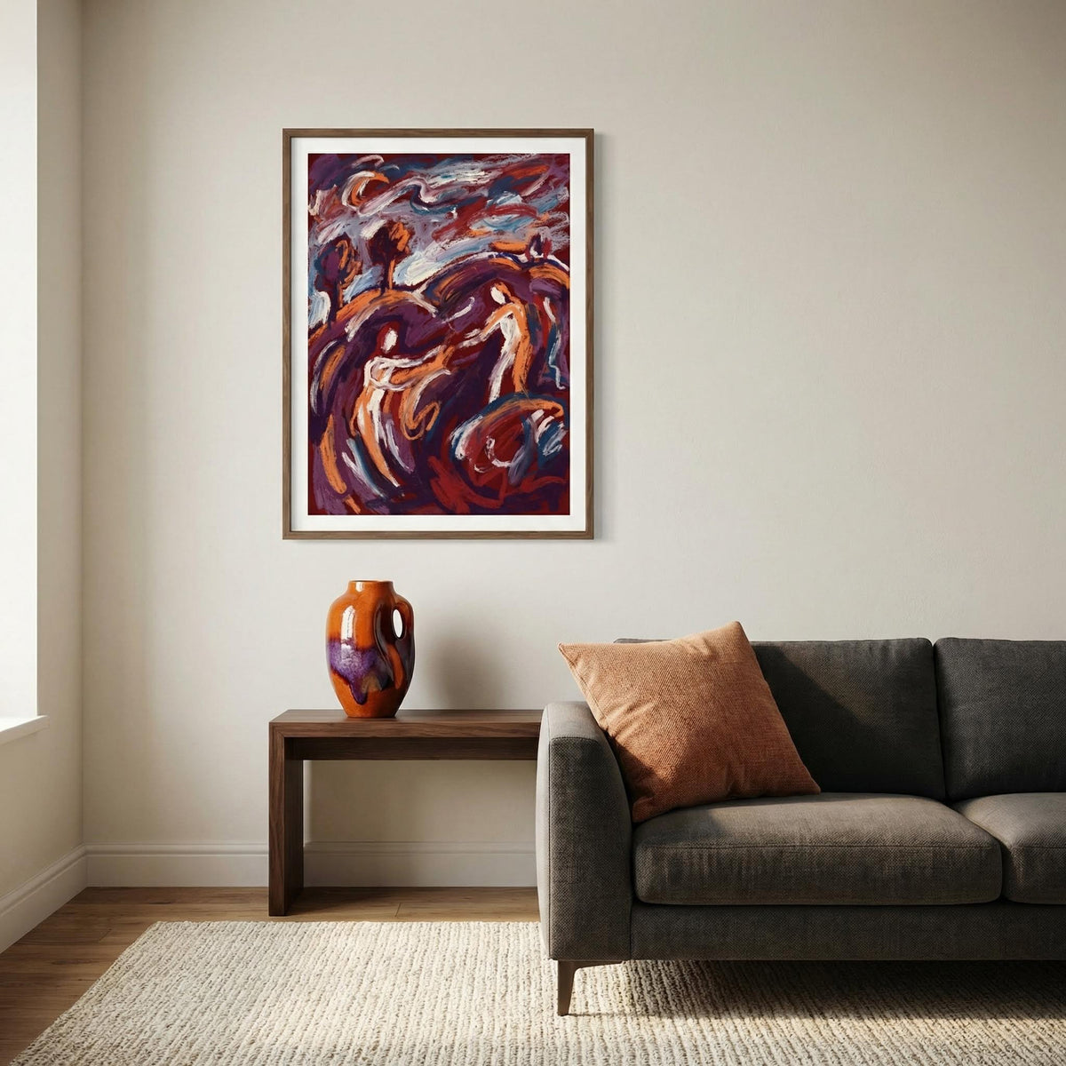 Abstract Couple Art Print on a wall above a wooden table with an orange vase and a grey sofa