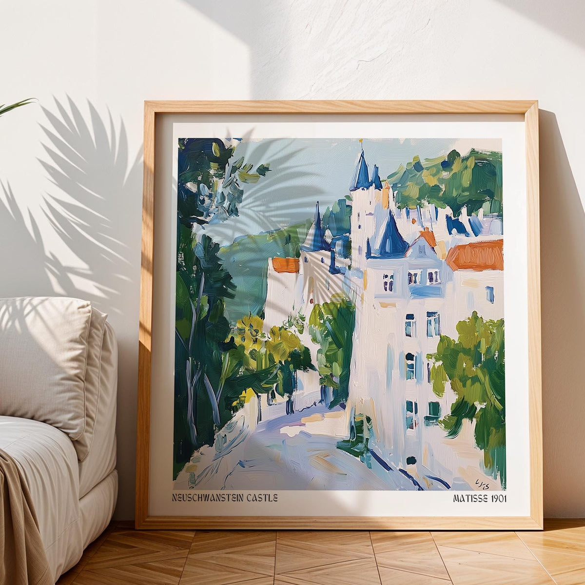 Print of medieval castle art in watercolour style with blue and green tones beside cream sofa